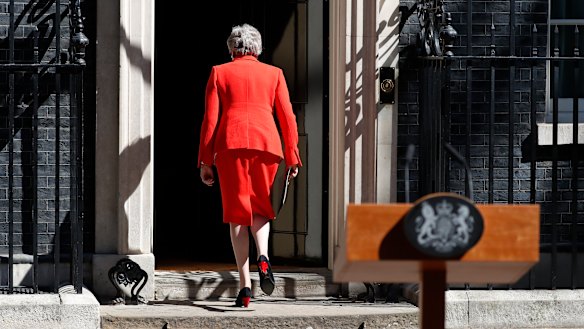 British Prime Minister Theresa May walks away after making a speech in the street outside 10 Downing Street.