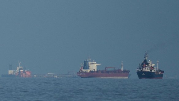 Oil tankers and cargo ships line up in the Strait of Hormuz.