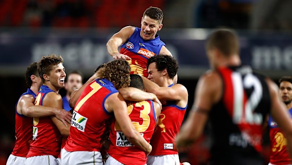 Pride of the Lions: Dane Zorko celebrates after Connor Ballenden kicked his first AFL goal during Brisbane's win over Essendon at Metricon Stadium.