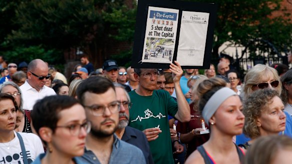 People walk in silence during a vigil in response to the shooting in the Capital Gazette newsroom.