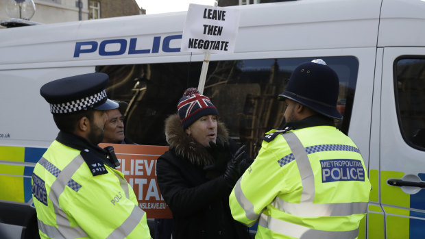 Police speak to a Leave campaigner outside Parliament in London on Tuesday.