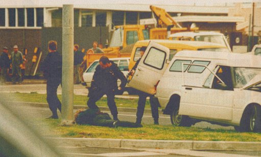 Stephen Asling is arrested by the special operations group in 1992. Fellow bandit Normie Lee was shot dead. The Dogs took these photos.