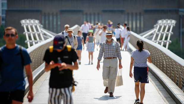 Pedestrians cross London’s Millennium Bridge on so-called Freedom Day.