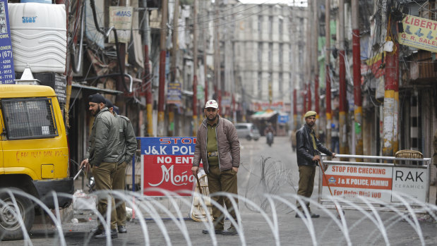 Indian policemen keep vigil during the fourth consecutive day of curfew in Jammu,  Kashmir state, India.