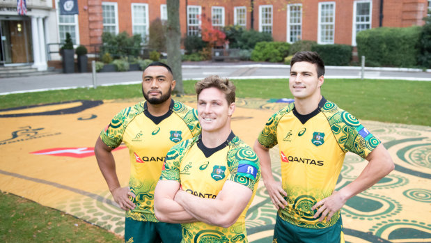 Honouring heritage: Sekope Kepu, Michael Hooper and Jack Maddocks stand in front of a supersized Wallabies Indigenous jersey in front of their team hotel in London. 