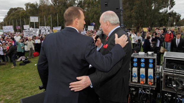 Then opposition leader Tony Abbott is embraced by broadcaster Alan Jones after he addressed the 'no-confidence' rally outside Parliament House in Canberra.
