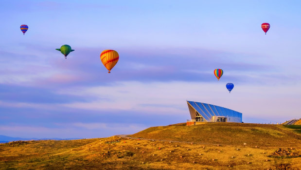 Balloons rising over the Margaret Whitlam Pavilion at the National Arboretum. 