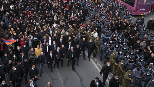 Armenian Prime Minister Nikol Pashinyan, centre front left carrying a megaphone, walks with his wife Anna Akobyan and supporters surrounded by bodyguards in Yerevan, Armenia. 