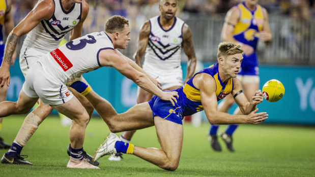 West Coast's Brad Sheppard gets a handball away in the round-four match against Fremantle.