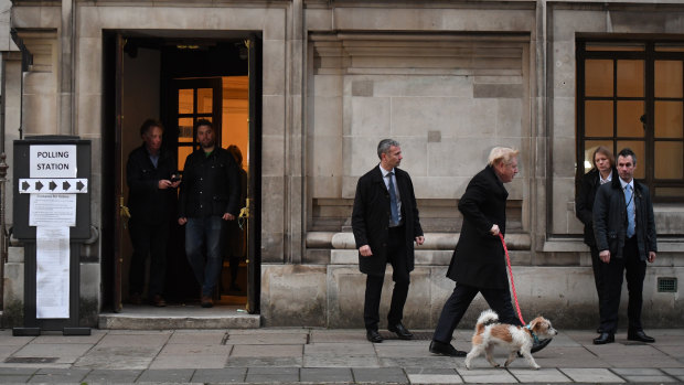 Prime Minister Boris Johnson leaves a voting booth in central London.