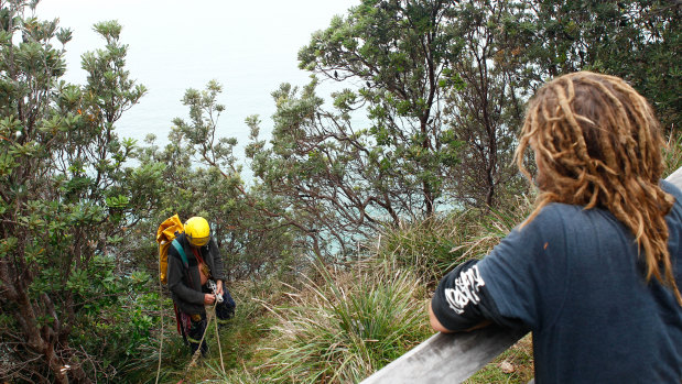 Local searchers abseil cliffs in Cape Byron looking for clues into the disappearance of Theo Hayez.