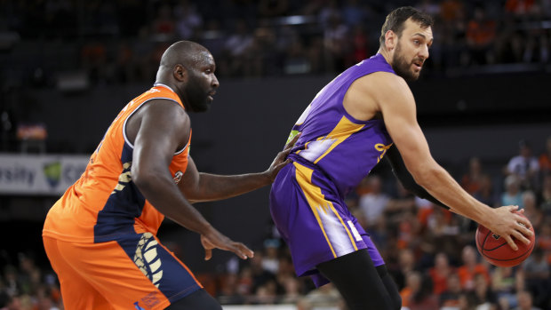 Key men: Andrew Bogut of the Kings, right, tries to get the better of Cairns' Nathan Jawai.