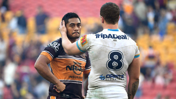 Broncos five-eighth Anthony Milford is consoled by Jarrod Wallace  of the Titans.