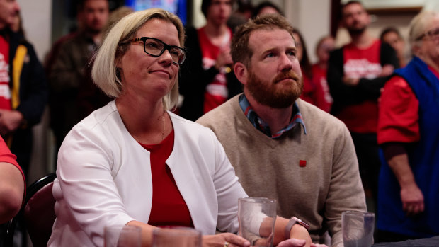 Hannah Beazley, Labor candidate for Swan and her husband Andrew Canion watch Bill Shorten's concession speech on TV at the Belmont Sports and Recreation Club.