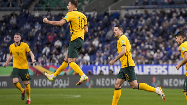 Australia’s Ajdin Hrustic leaps in the air as he celebrates after scoring his team’s first goal.