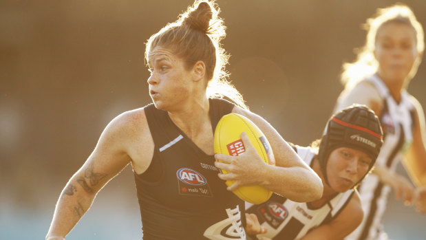 Bri Davey bursts out of a tackle against Collingwood.