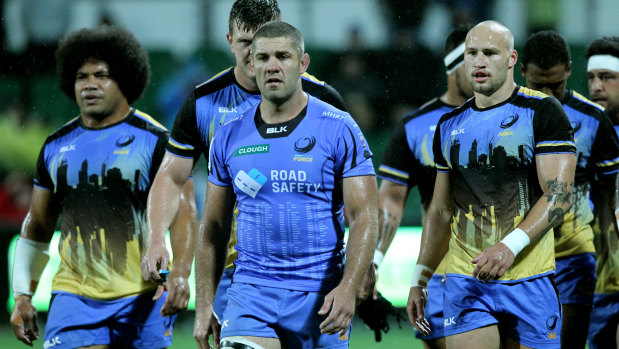 Dark days: Matt Hodgson, centre, and teammates after the Western Force's last Super Rugby game.