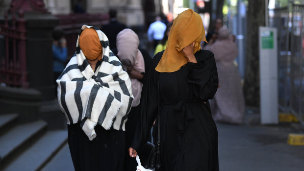 Asha Ali (right), sister of Ali Khalif Shire Ali, departs the Supreme Court of Victoria in Melbourne on Thursday.