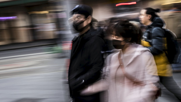 People wearing face masks during flu season in Sydney's Haymarket.