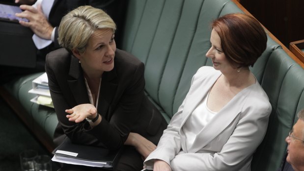 Tanya Plibersek and Julia Gillard during question time in Parliament in 2012.