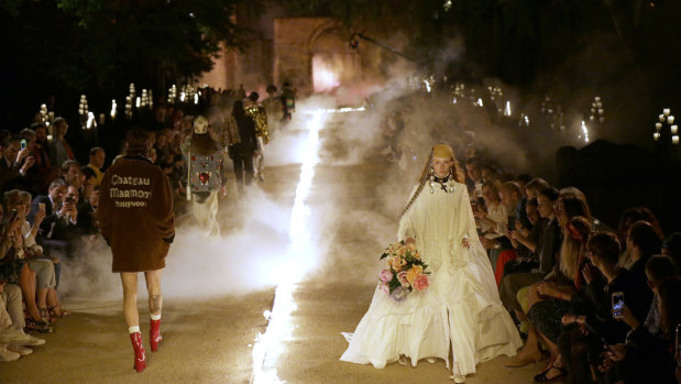 Models wear creations for Gucci's Cruise 2019 fashion collection at the ancient site of Alyscamps in Arles, southern France on May 30.