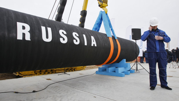 A Russian construction worker speaks on a mobile phone in Portovaya Bay, north-west from St. Petersburg, Russia, during a ceremony marking the start of Nord Stream pipeline construction in 2010.