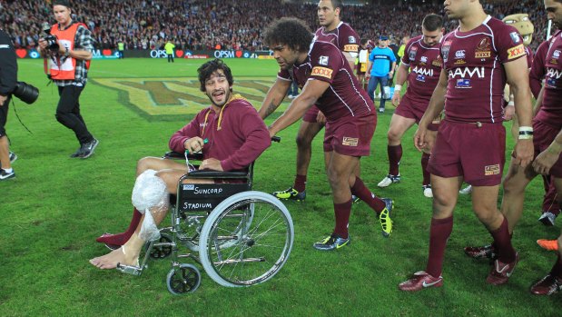 Johnathan Thurston was part of the Maroons' celebrations, despite injuring his knee.