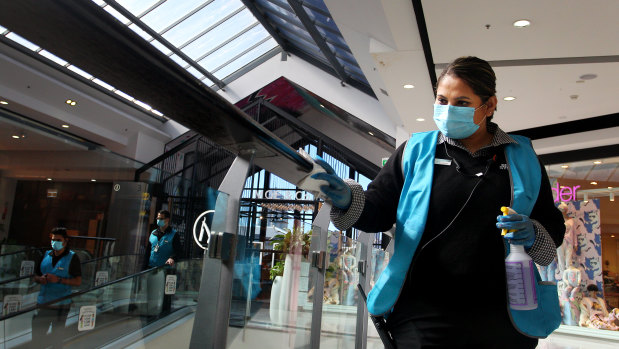 Keeping it clean: a member of  the Broadway Shopping Centre's presentation and hygiene team cleans handrails at the centre.