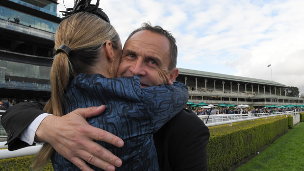 Chris Waller hugs wife Stephanie at Randwick on Saturday.