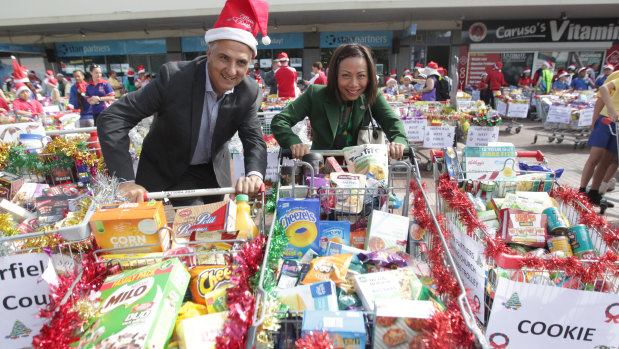 Stocking up: Locals join in the Fairfield Uniting Church Christmas shopping trolley drive earlier this month.