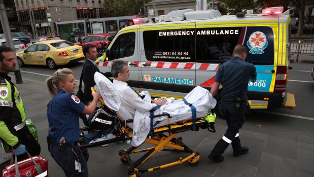 Dover responsible manager and owner Terry McMaster leaves the Federal Court with the aid of paramedics after collapsing while being questioned.