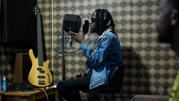 Jean Patrick Niambe, a hip-hop artist known as Dofy who often composes in Nouchi, a slang once crafted by petty criminals, records a new song in a studio in Abidjan, Ivory Coast.