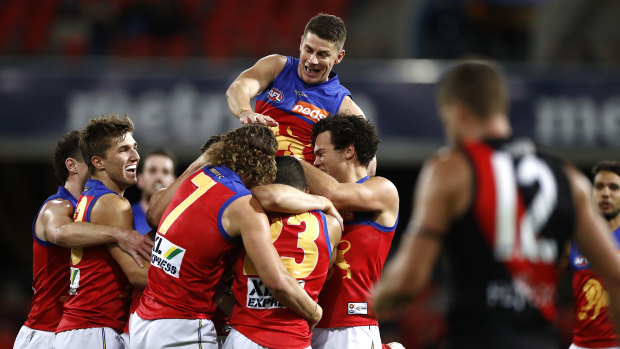 Pride of the Lions: Dane Zorko celebrates after Connor Ballenden kicked his first AFL goal during Brisbane's win over Essendon at Metricon Stadium.
