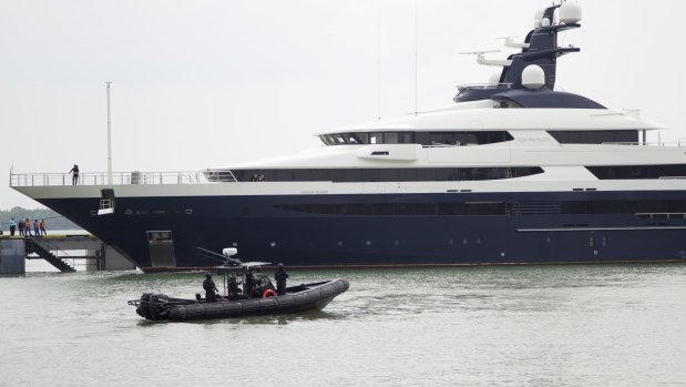 From their boat, Malaysian marine police watch the Equanimity arrive at Port Klang, Malaysia, on Tuesday.