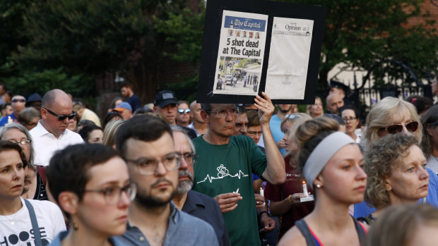 People walk in silence during a vigil in response to the shooting in the Capital Gazette newsroom.