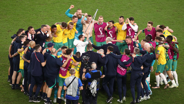 Graham Arnold and his team celebrate the historic win over Denmark.