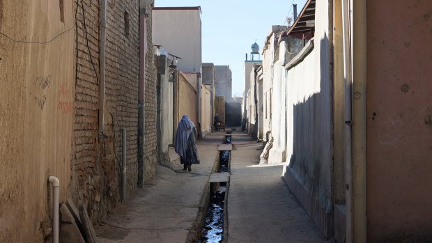 A woman wearing a burqa walks the streets of Kabul. 