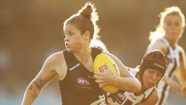 Bri Davey bursts out of a tackle against Collingwood.