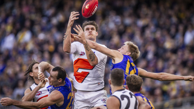 Eyes on the prize: GWS forward Rory Lobb rises above the pack.
