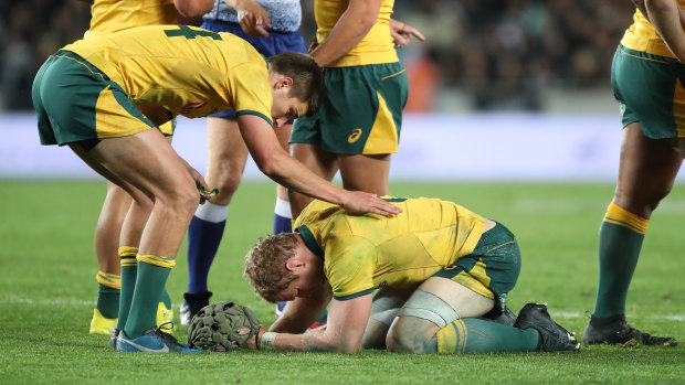 Targeted: David Pocock doubles over after the Wallabies' heavy defeat by the All Blacks.