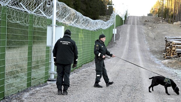 Guards patrol a trial border fence at the Finnish-Russian border in Imatra, Finland.