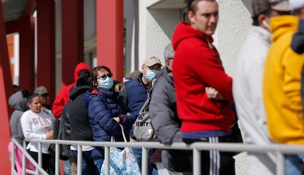 People wait in line to collect their unemployment benefits in Las Vegas.