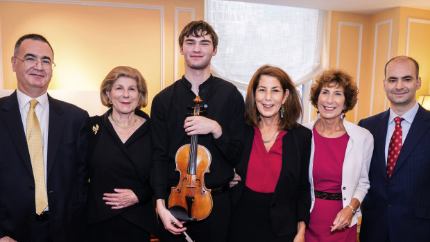 From left are Bruno Price, of Rare Violins of New York, Nina Totenberg, Meltzer with the instrument, Amy Totenberg, Jill Totenberg and Ziv Arazi of Rare Violins of New York. 