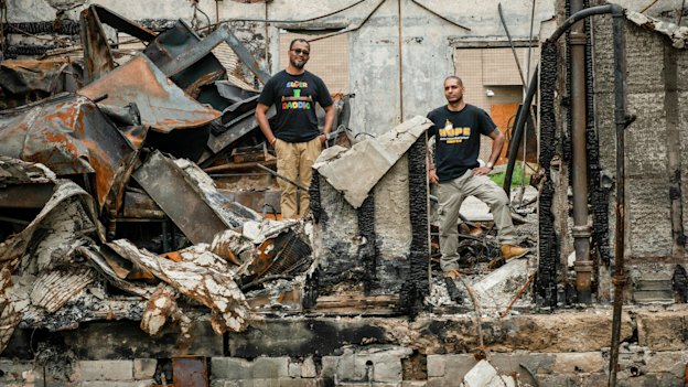 Ruhel Islam in the ruins of his Minneapolis restaurant, Gandhi Mahal, which was destroyed in the riots after George Floyd's death. Pictured here with his manager  and friend, Pastor Riz Prakasim. 