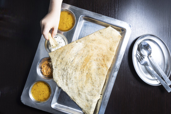 Tear the dosa, dip it in sambar and enjoy.