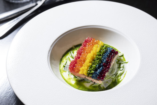 The “rainbow” trout is striped with finger lime, salmon roe, chopped chives and dashi pearls.