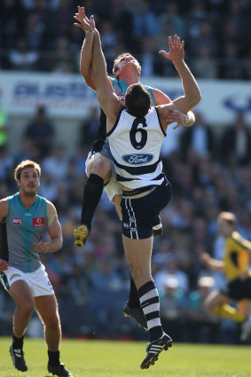 Geelong’s Brad Ottens tangles in the air  with Port’s Dean Brogan .