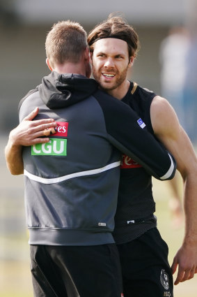 Nathan Buckley hugs Matthew Scharenberg during training on Wednesday. 