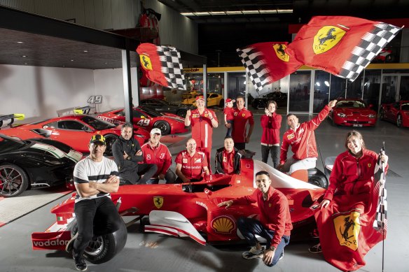 Tony De Felice (left) and daughter Laura De Felice at Casa Ferrari, a huge storage facility in Melbourne’s East that houses his and others’ Ferraris. They’re pictured with members of the Ferrari Club of Australia. 