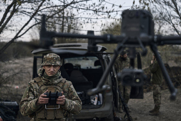 A Ukrainian soldier launches a drone in Bakhmut, the location of one of the bloodiest battles of the war.